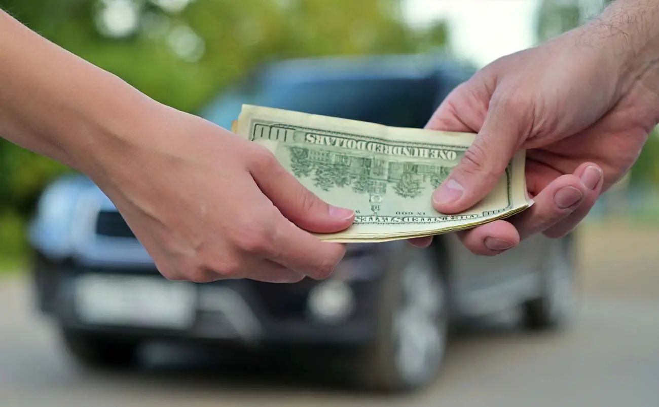 man purchasing used car in cash