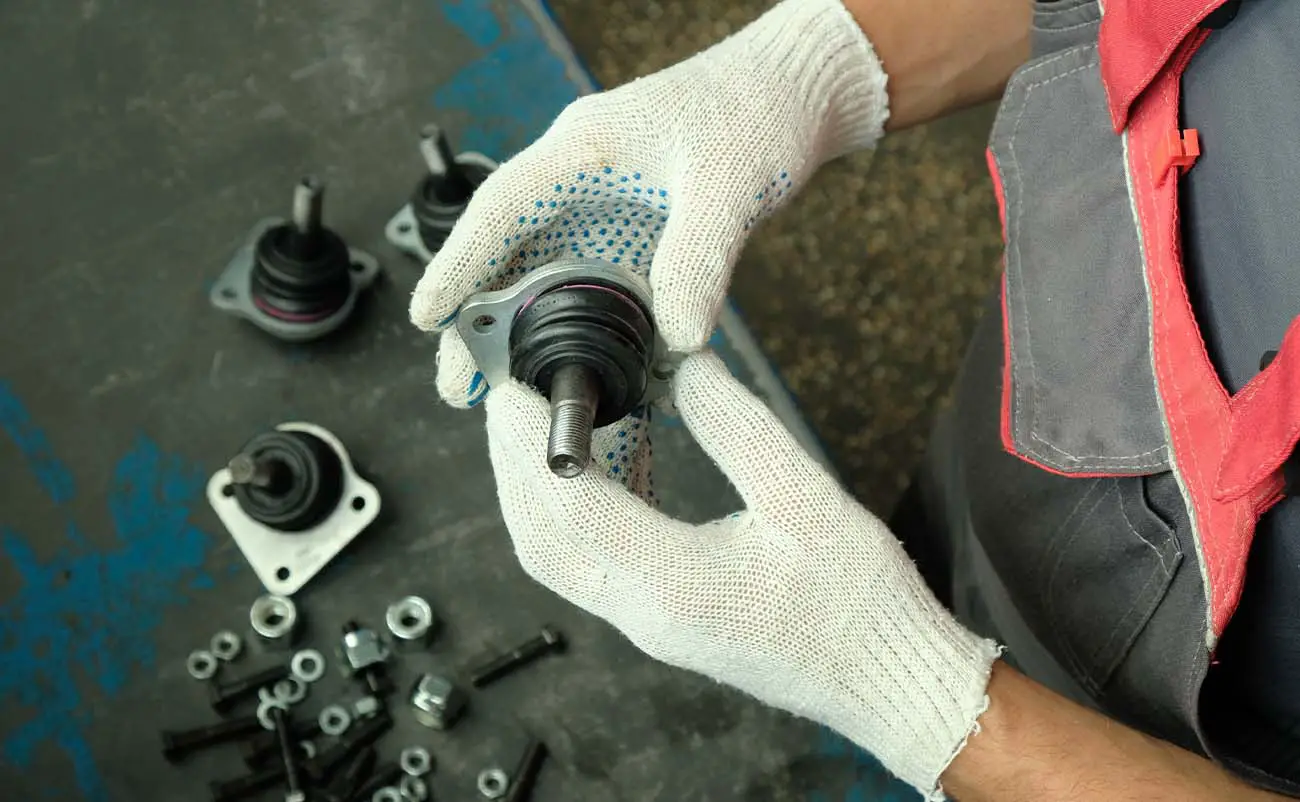 mechanic inspecting ball bearings in hand