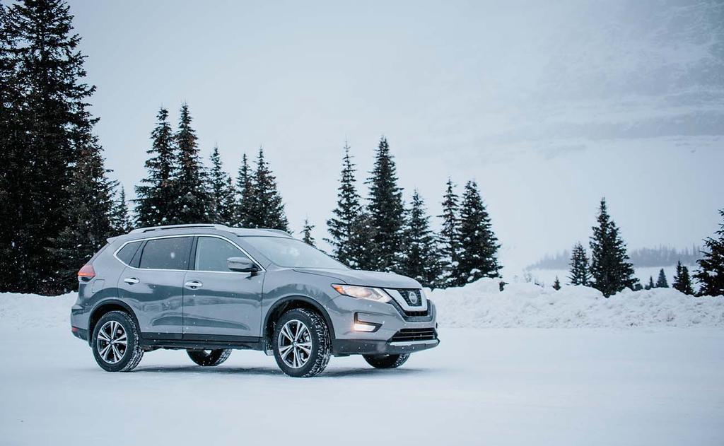 grey nissan rogue parked in snowy winter scene