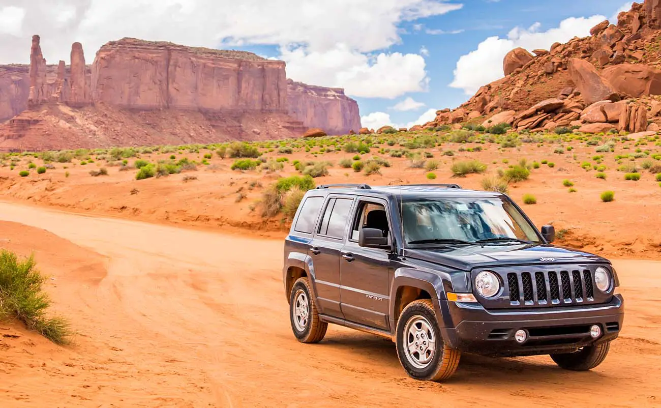 jeep patriot sub parked in monument valley utah